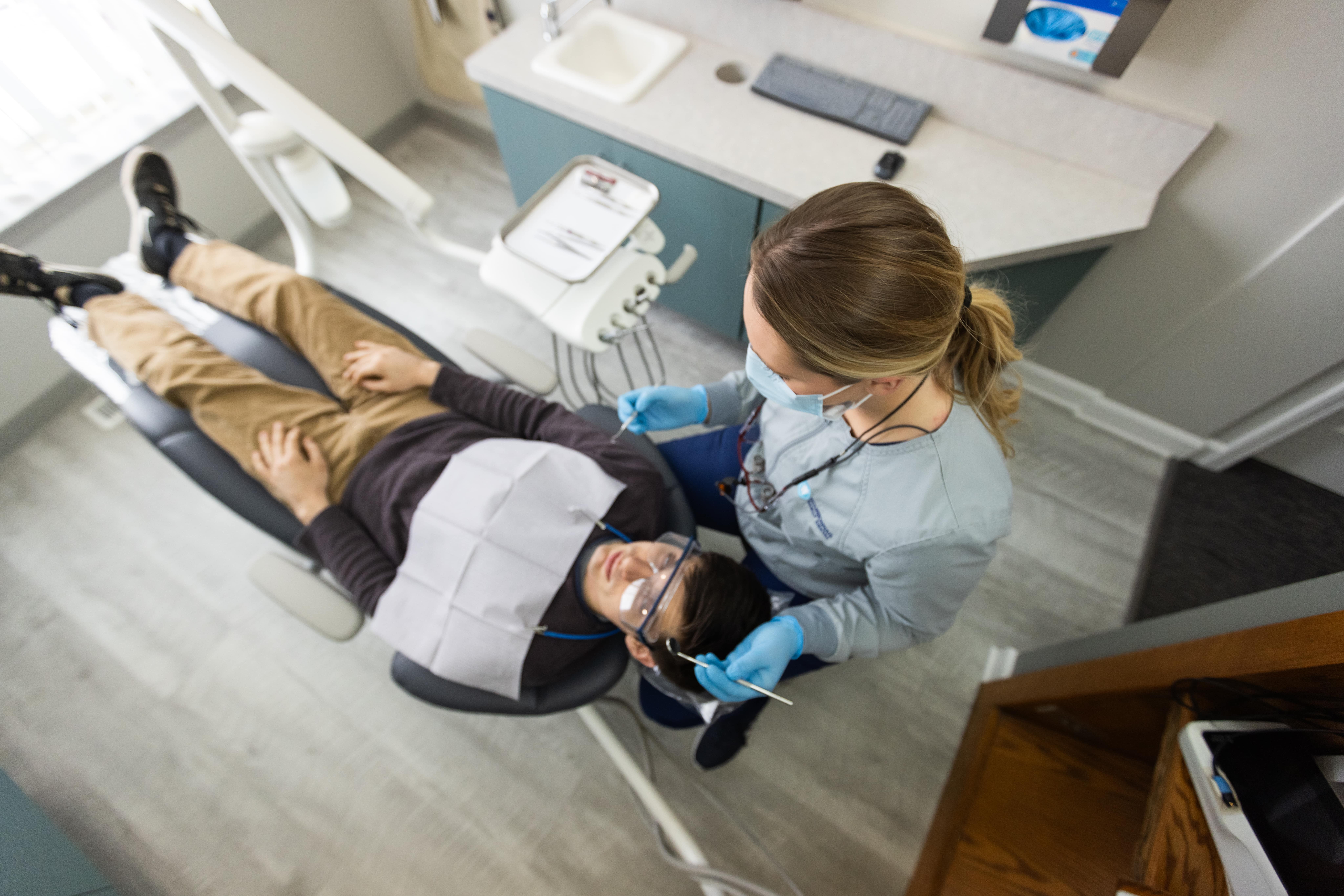 Female dentist explaining digital scan results to female patient