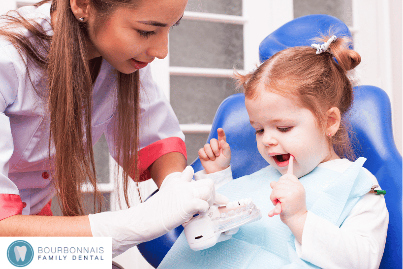 Female dentist caring for young child patient.